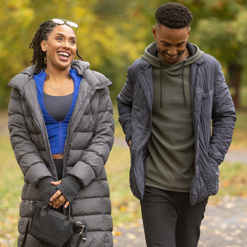 man and woman walking outside in coats
