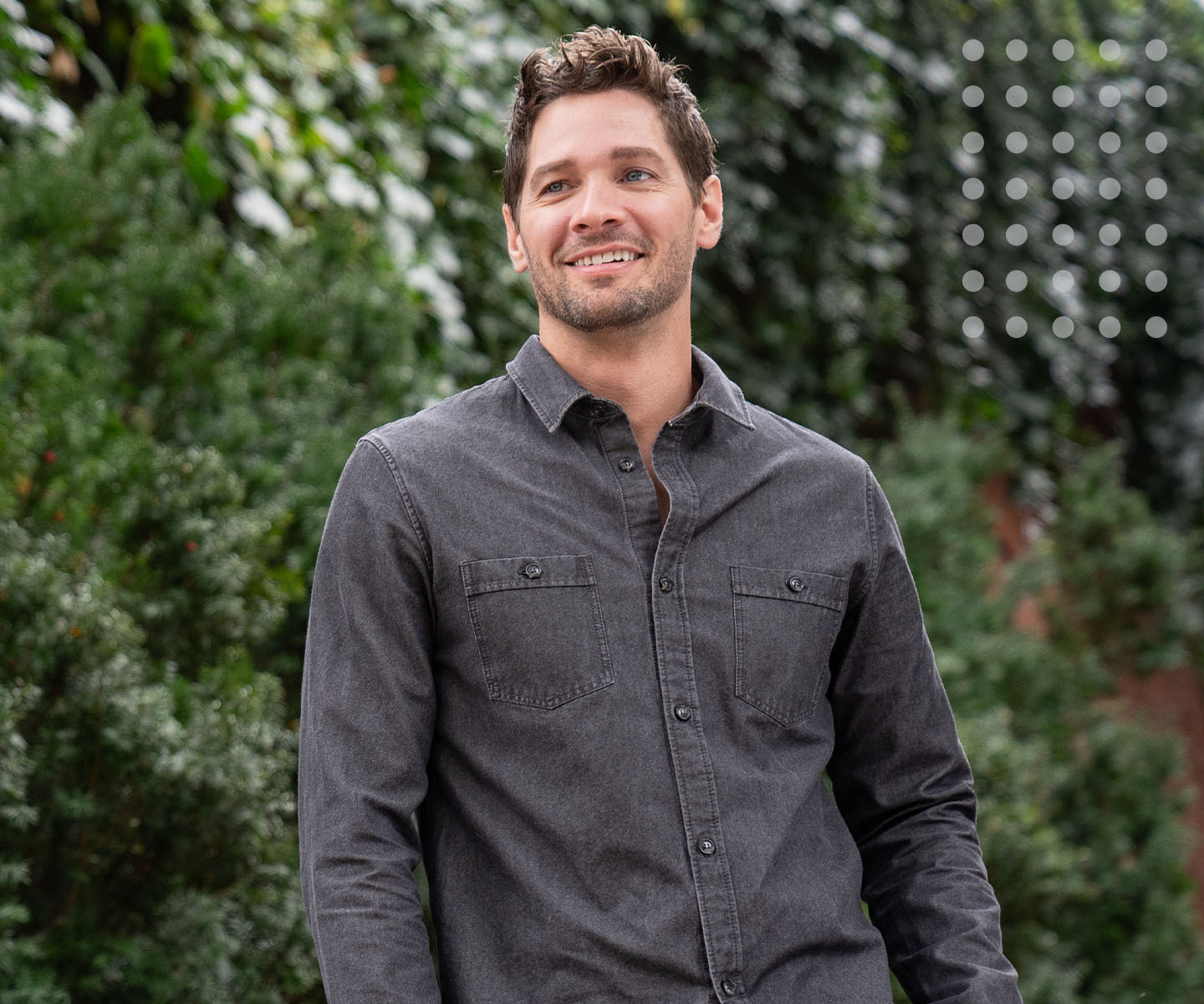 Man posing by trees