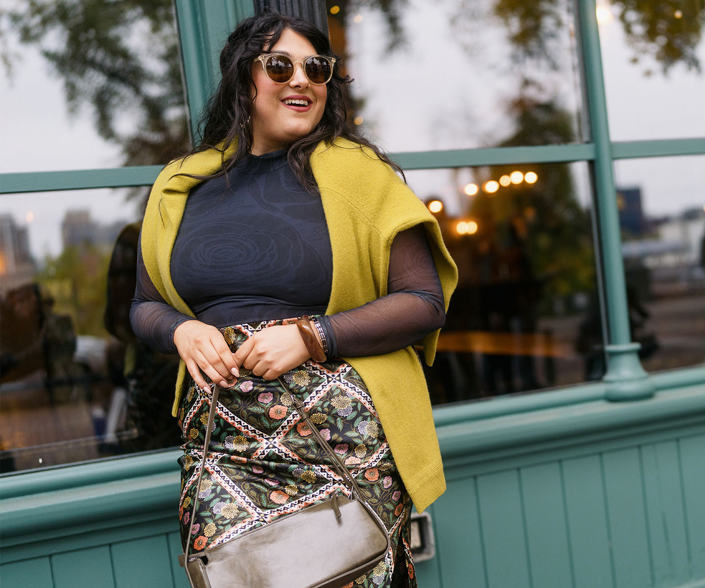 women outside holding purses and accessories