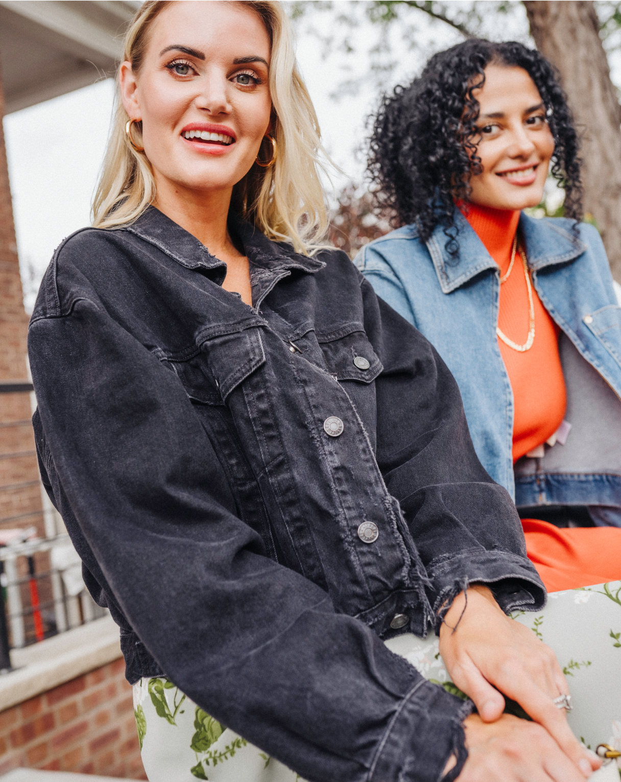 Smiling women wearing jean jackets