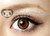Closeup, CM-834 Angel Brown colored contact lens on brown eye.