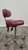 Side view of actual BQE ergonomic doctor stool with burgundy upholstery