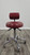 Back view of actual BQE ergonomic doctor stool with burgundy upholstery