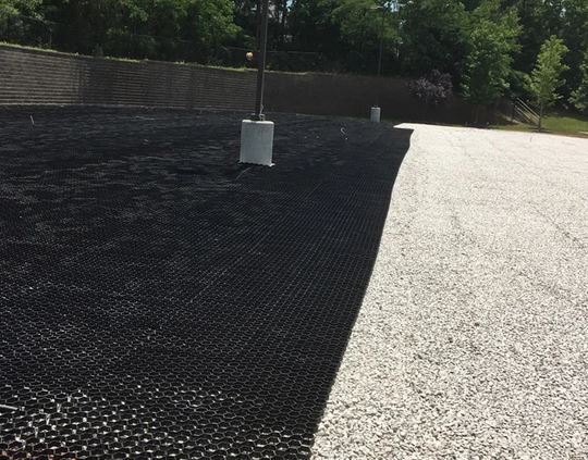 Grass paver roll being installed over a prepared base