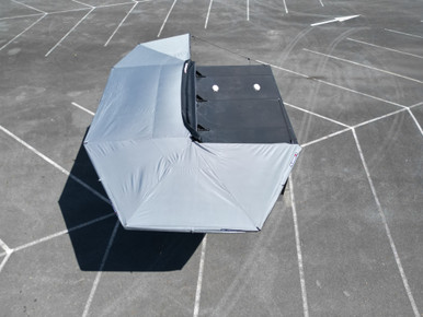 4WD camp set up with a Rugged 4x4 awning, table and chairs deployed to the rear of the vehicle