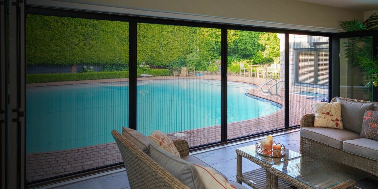Retractable screens for large window in a home