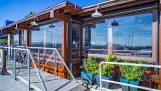 A cafe using their motorized retractable vinyl screens to keep out bugs and keep patrons comfortable. 