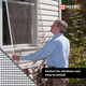 Man installing aluminum screen on a window, demonstrating easy-to-install bug mesh that fits residential window frames and provides superior small insect protection with high-visibility metal screening.