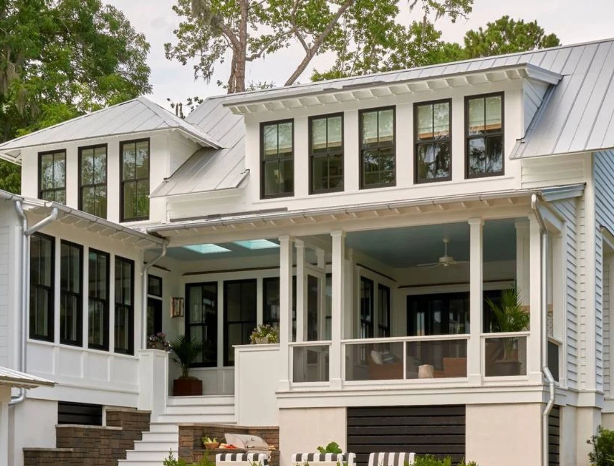 Screened porch openings on a two story home with white trim and black framed windows