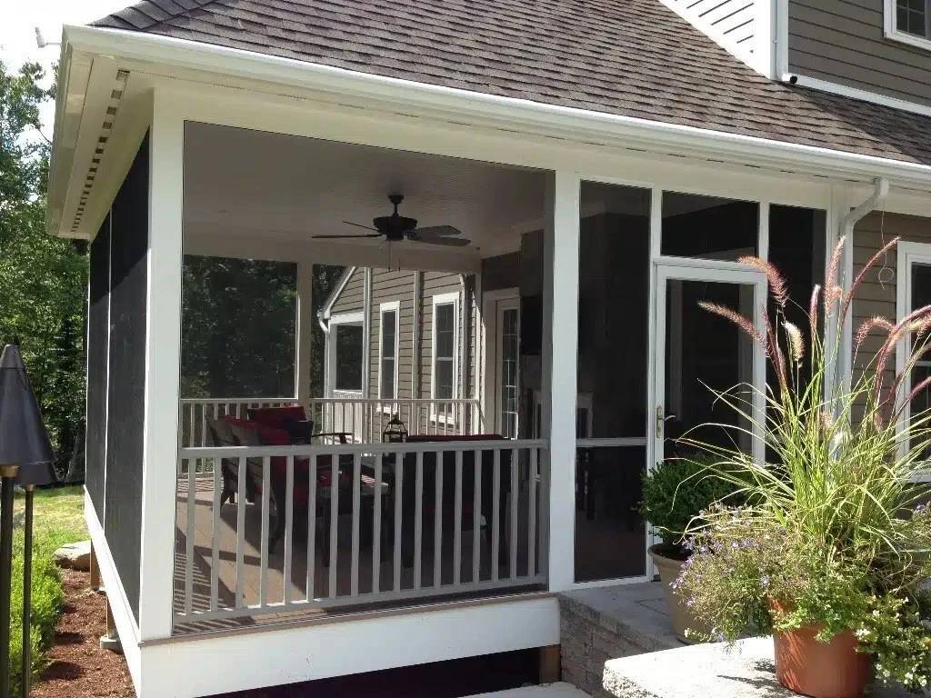 Screened in porch with black mesh panels and white trim on a residential deck