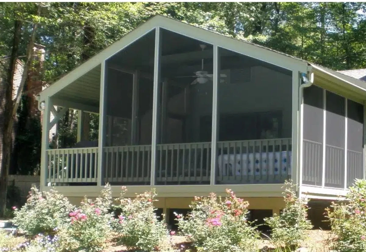 Gable end screened porch with full height mesh panels on a wooded lot
