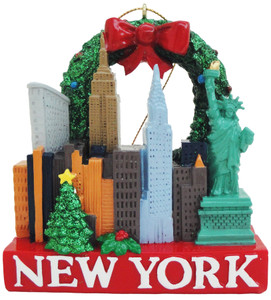 A Christmas Ornament showcasing famous landmarks from New York City, like the statue of liberty, the Empire State Building, and the famous New York skyline. On the bottom is written New York. A Christmas Ornament showcasing famous landmarks from New York City, like the statue of liberty, the Empire State Building, and the famous New York skyline. On the bottom is written New York.