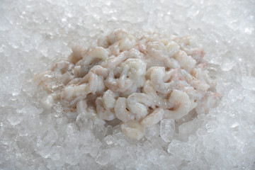 Tail-off Biloxi Gulf shrimp frozen on ice.