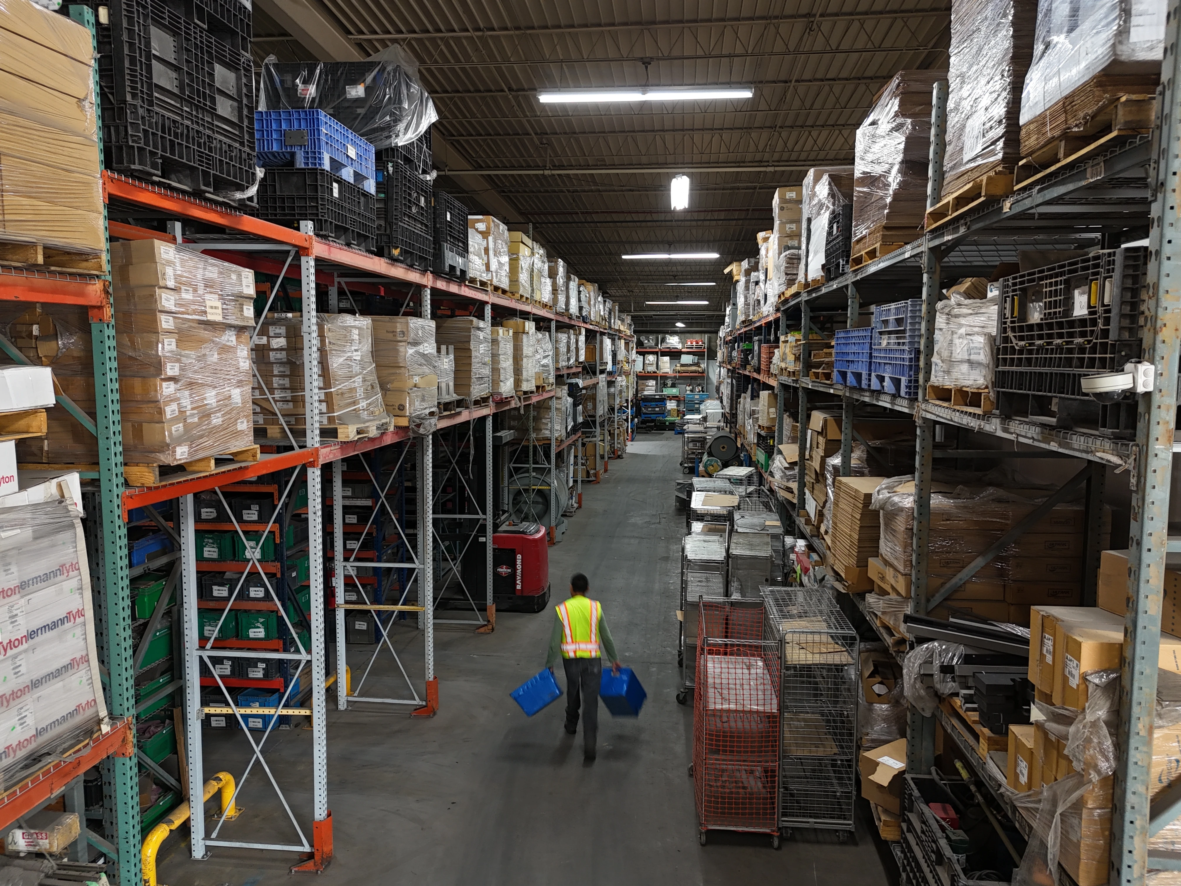Team member walking a warehouse aisle