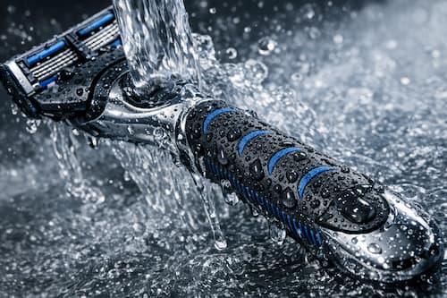 Ergonomic body razor handle designed for wet conditions.