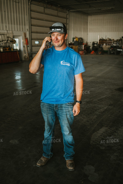 Farmer on Phone in Farm Shop 6208