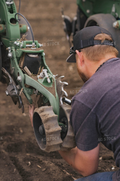 Farmer Repairing Planter 91009