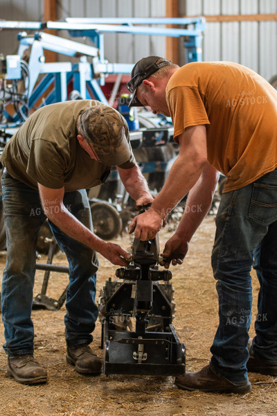 Farmers Working in Shed 50267