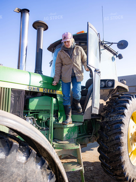 Rancher Getting Out of Tractor 70218