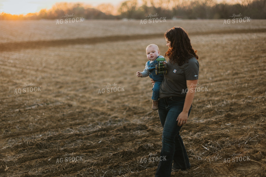 Farmer Holding Farm Kid in Field 7460