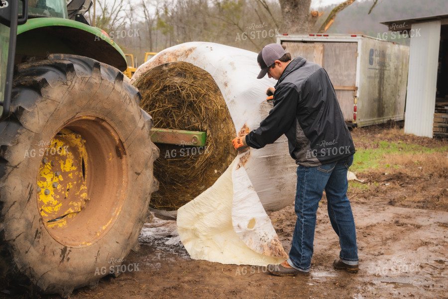 Farmer Wrapping Hay Bale 128010