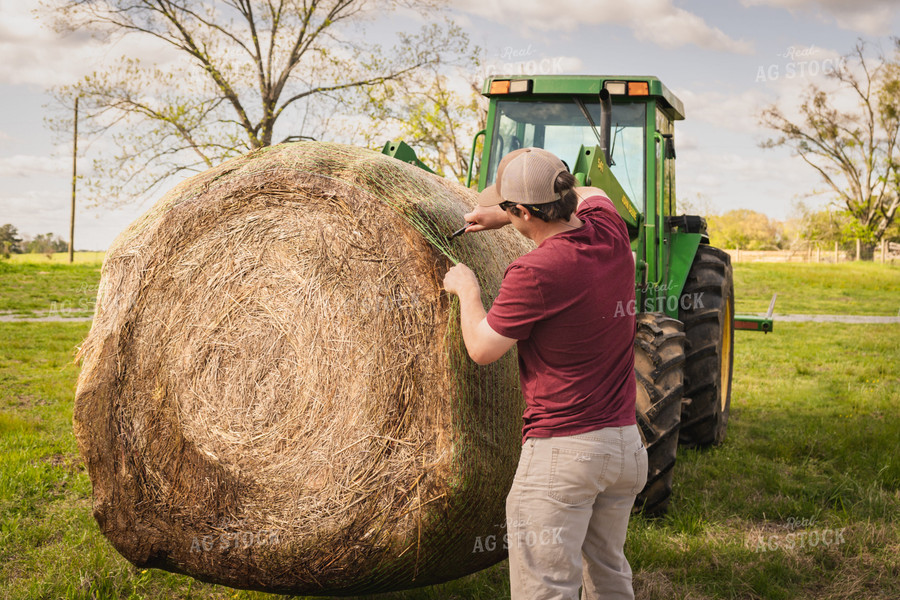 Farmer Unwrapping Hay Bales 128015
