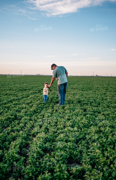 Farmer and Farm Kid Standing in Field 56614