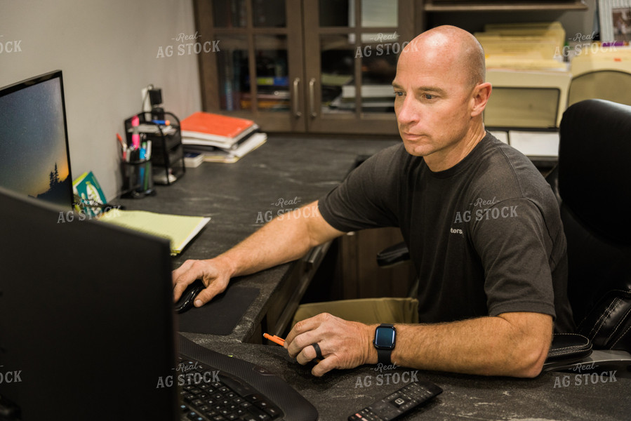 Farmer Works on Computer in Office 7492