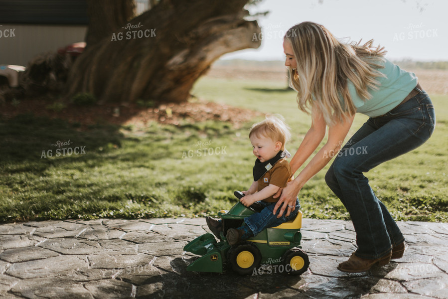 Young Boy is Pushed on Toy Combine by Mother 7635