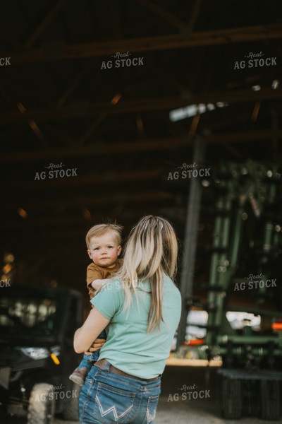 Farm Wife and Child Stand in Shed 7643