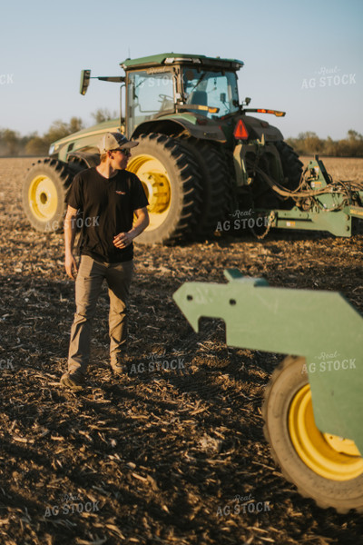 Young Farmer Walks Away from Tractor 7698