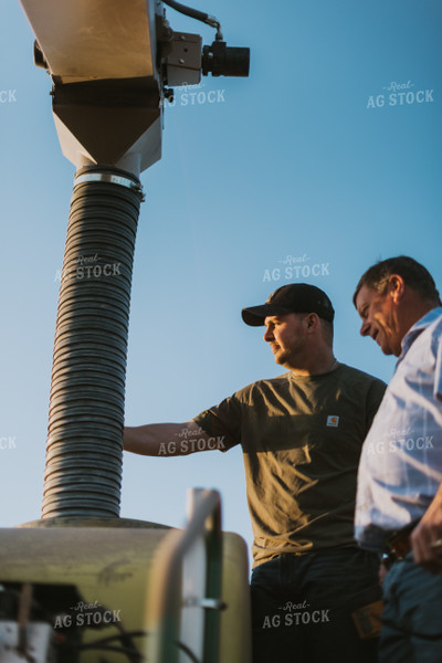 Farmers Fill Planter with Seed Tender in Field 7710