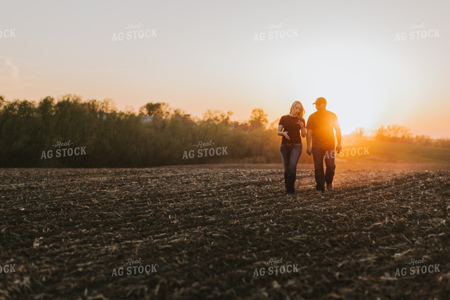 Young Couple Walk in Field at Sunset 7725