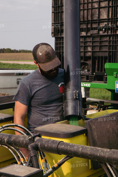 Farmer Loading Planter Boxes with Seed Tender 67304