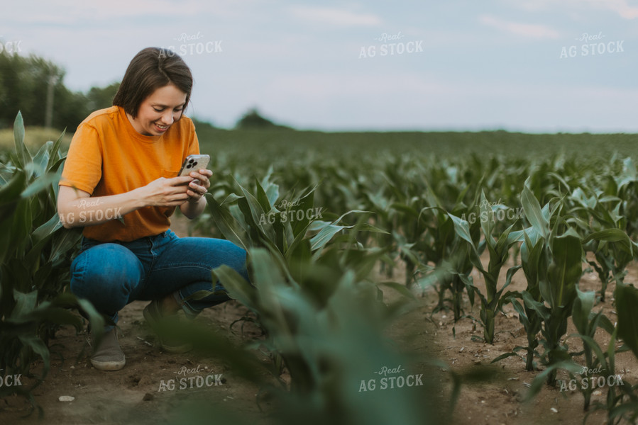 Female Farmer Takes Picture of Corn Plant 7840