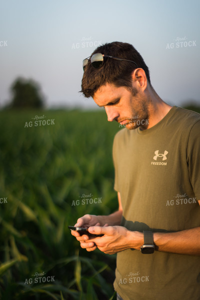 Young Farmer Using Phone in Corn Field 8159