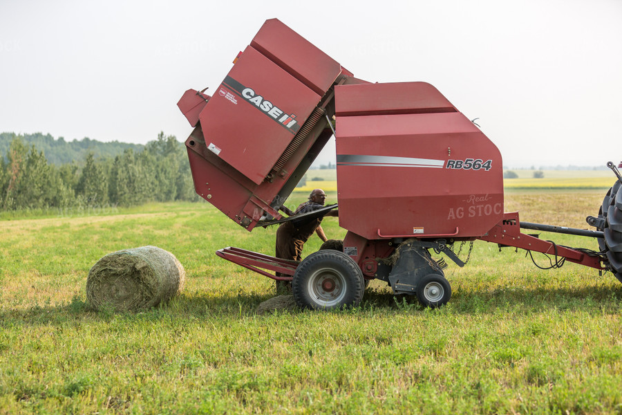 Farmer Fixing Baler 138068