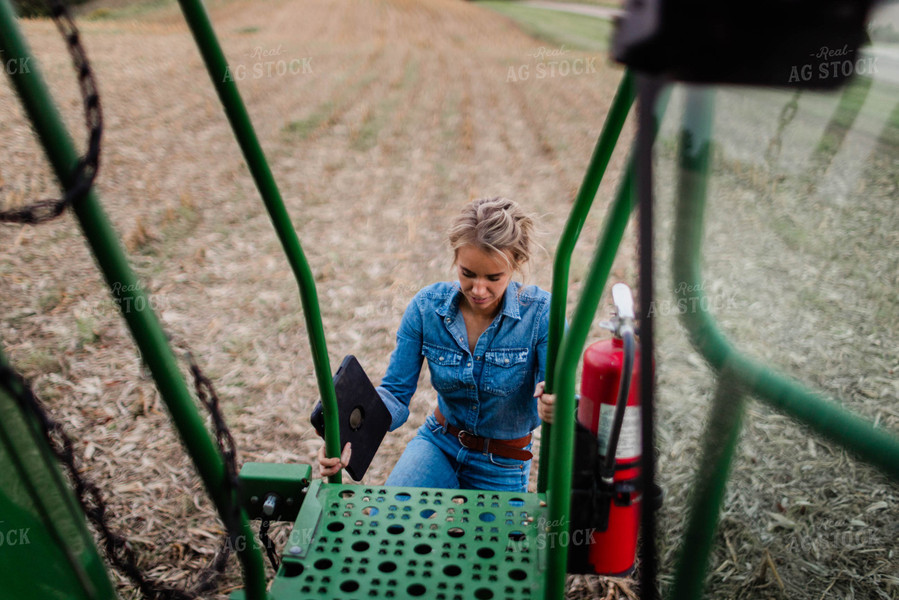 Female Farmer Climbing into Combine 8392