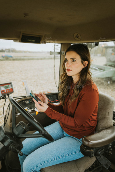 Female Farmer Using Phone in Tractor 8545