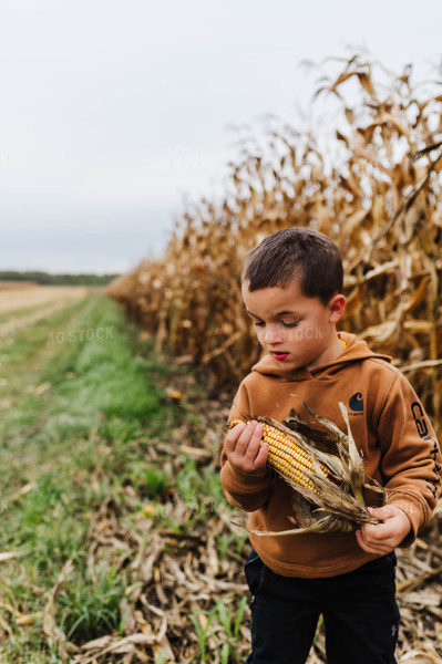Farm Kid Holding Ear of Corn 115096
