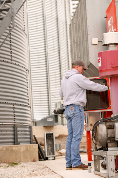 Farmer Checking Grain Dryer 161132