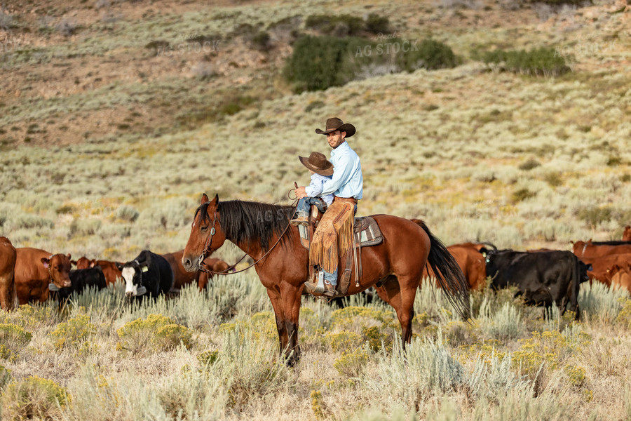 Rancher and Ranch Kid on Horseback 188044