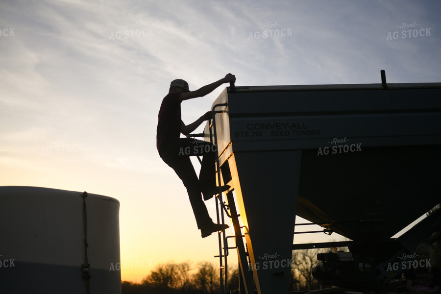 Farmer Climbing Down Seed Tender 191012