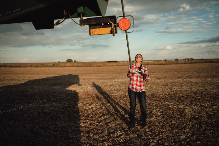 Female Farmer Tarping Grain Cart 3531