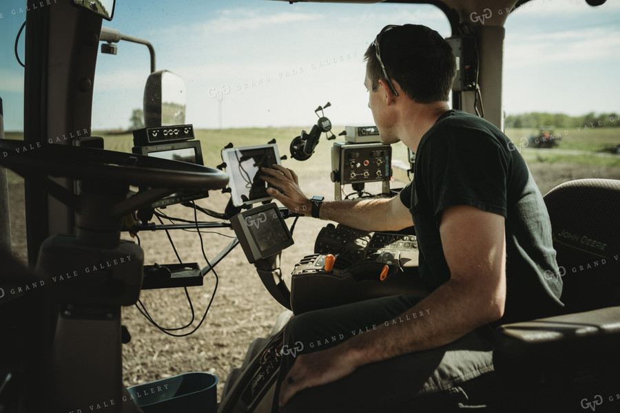 Farmer Adjusting Planter Monitor 4113