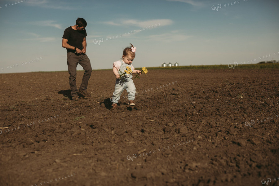 Farmer and Daughter Checking Seed Depth 4179