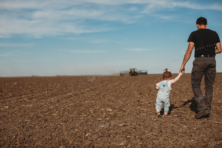 Farmer and Daughter with Tractor and Planter in Background 4183