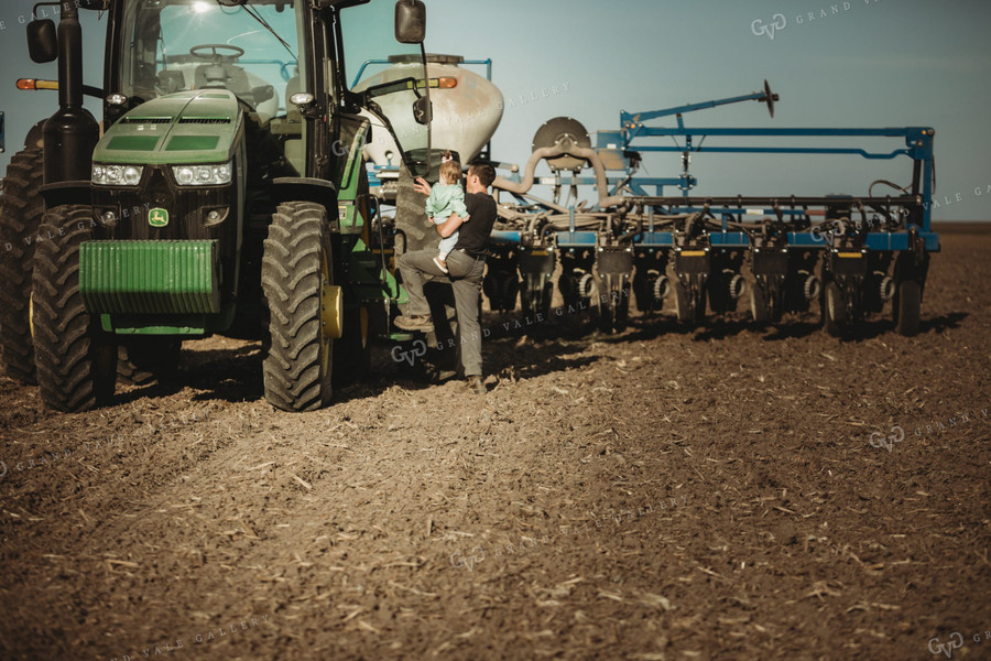 Farmer and Daughter Climbing into Tractor with Planter 4193