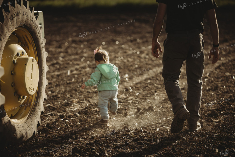Farmer and Daughter in Field with Tractor 4207