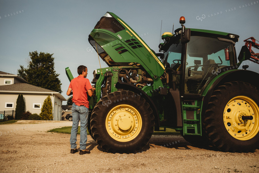 Farmer Checking Tractor Oil 4455